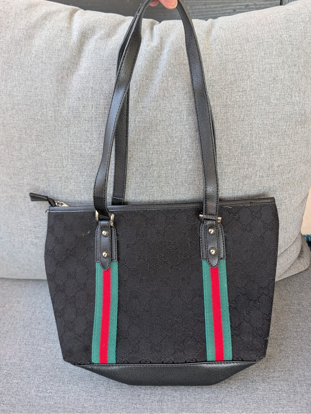 Gucci black tote bag with red and green details.